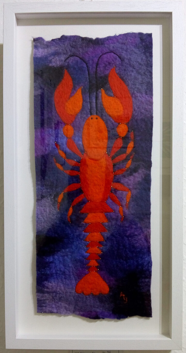 Felt picture of a bright orange lobster on a purple background