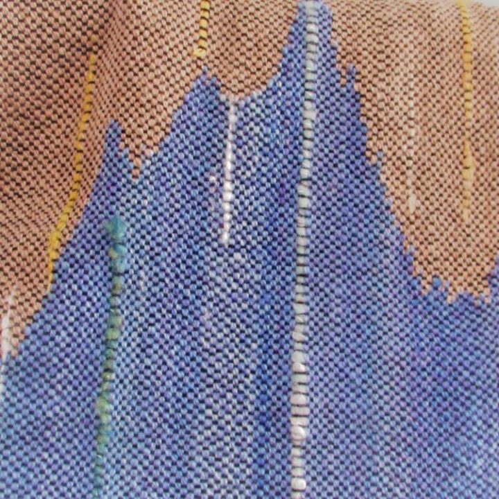 Detail of hand dyed, hand spun, hand woven scarf in blue and sandy brown inspired by the Cornish Coast