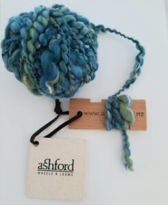 Polzeath Breeze handspun yarn being measured on the yarn gauge