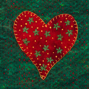 Greeting card image of a red felt heart blanket stitched with golden yellow thread onto a dark green felt background. The heart is embroidered with green flowers and golden yellow french knots and the green background is stitched with tiny red running stitch.