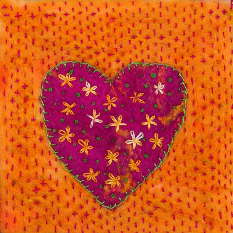 Greetings card image of a dark pink heart blanket stitched with green thread onto a vibrant orange felt background. The heart is embroidered with yellow orange flowers and green french knots. The background is embroidered with tiny deep pink running stitch.
