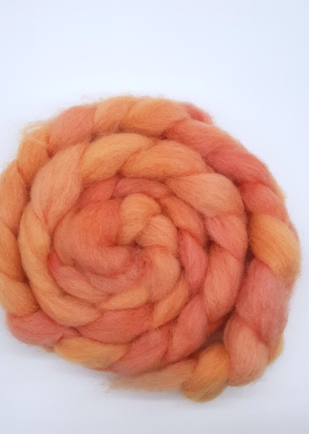 A braid of hand dyed Romney roving in shades of orange.