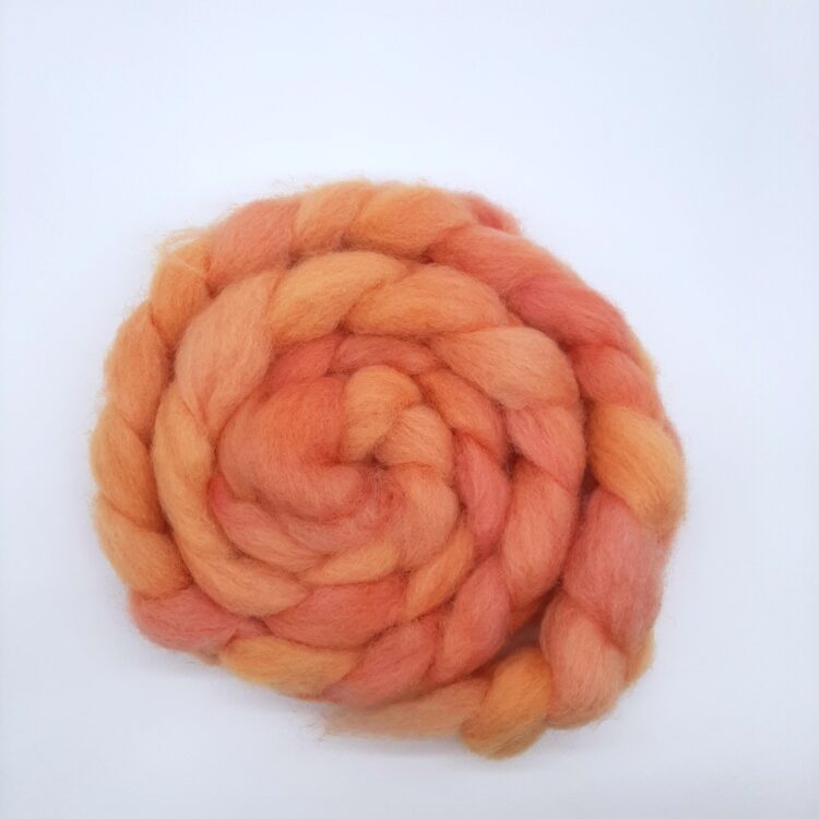 A braid of hand dyed Romney roving in shades of orange.