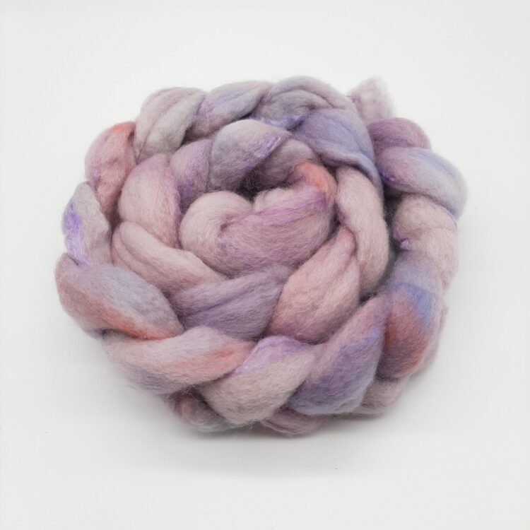 Hand dyed bluefaced leicester and silk fibre in shades of purples and a rosy blush, braided.