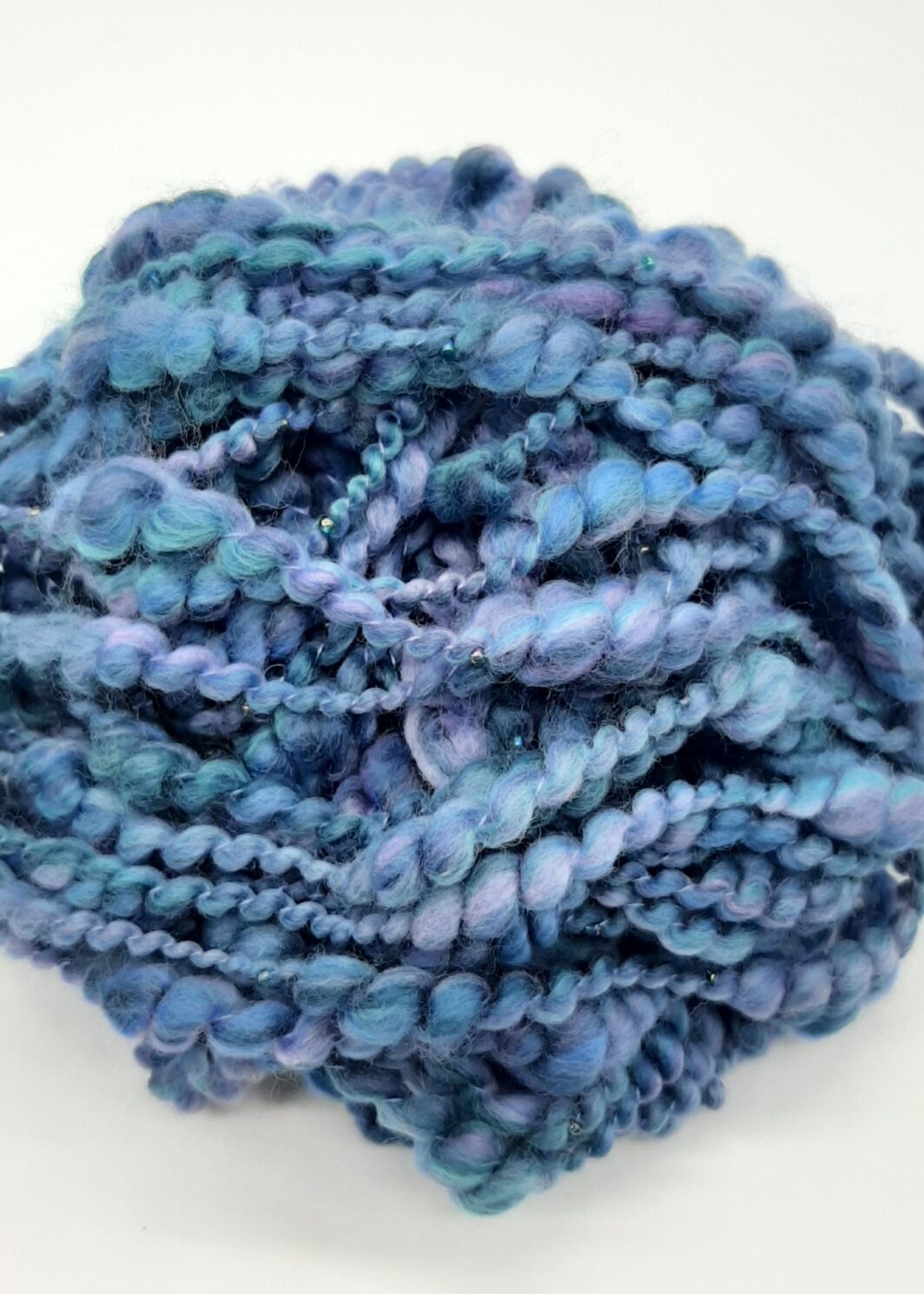 Daymer Storm handspun beaded merino yarn in blues with a hint of lilac.