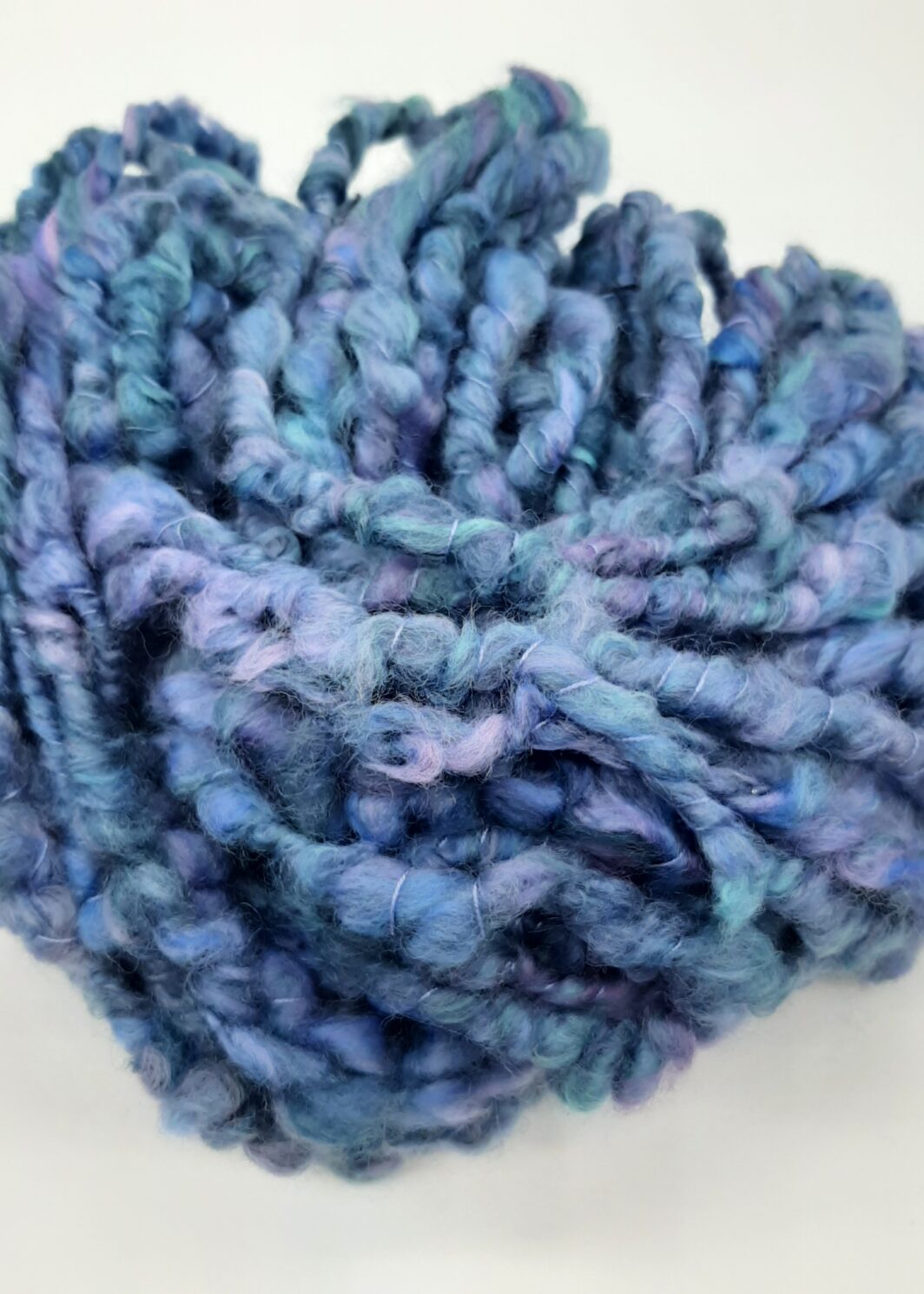 Daymer Storm handspun corespun merino yarn in blues with a hint of lilac.