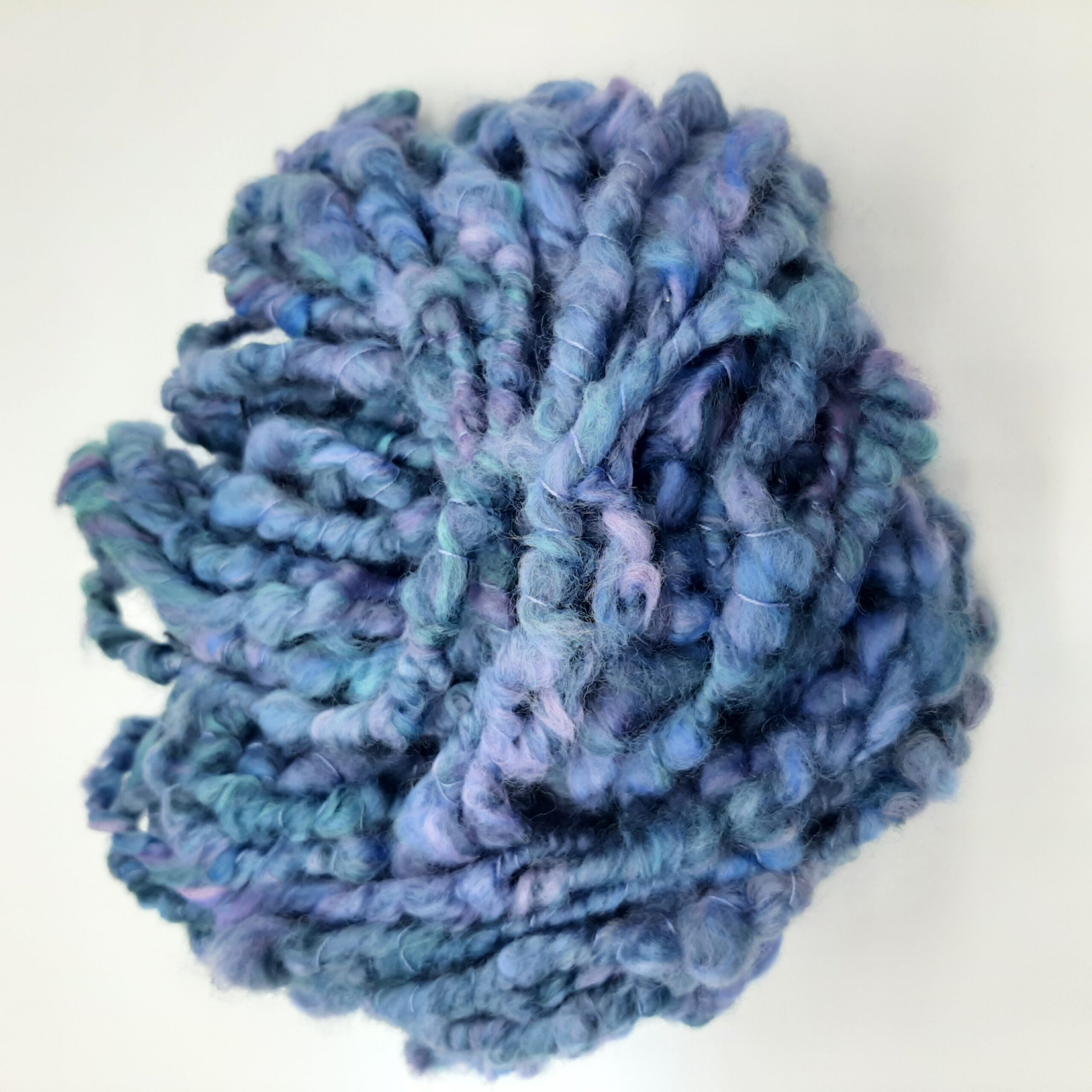 Daymer Storm handspun corespun merino yarn in blues with a hint of lilac.