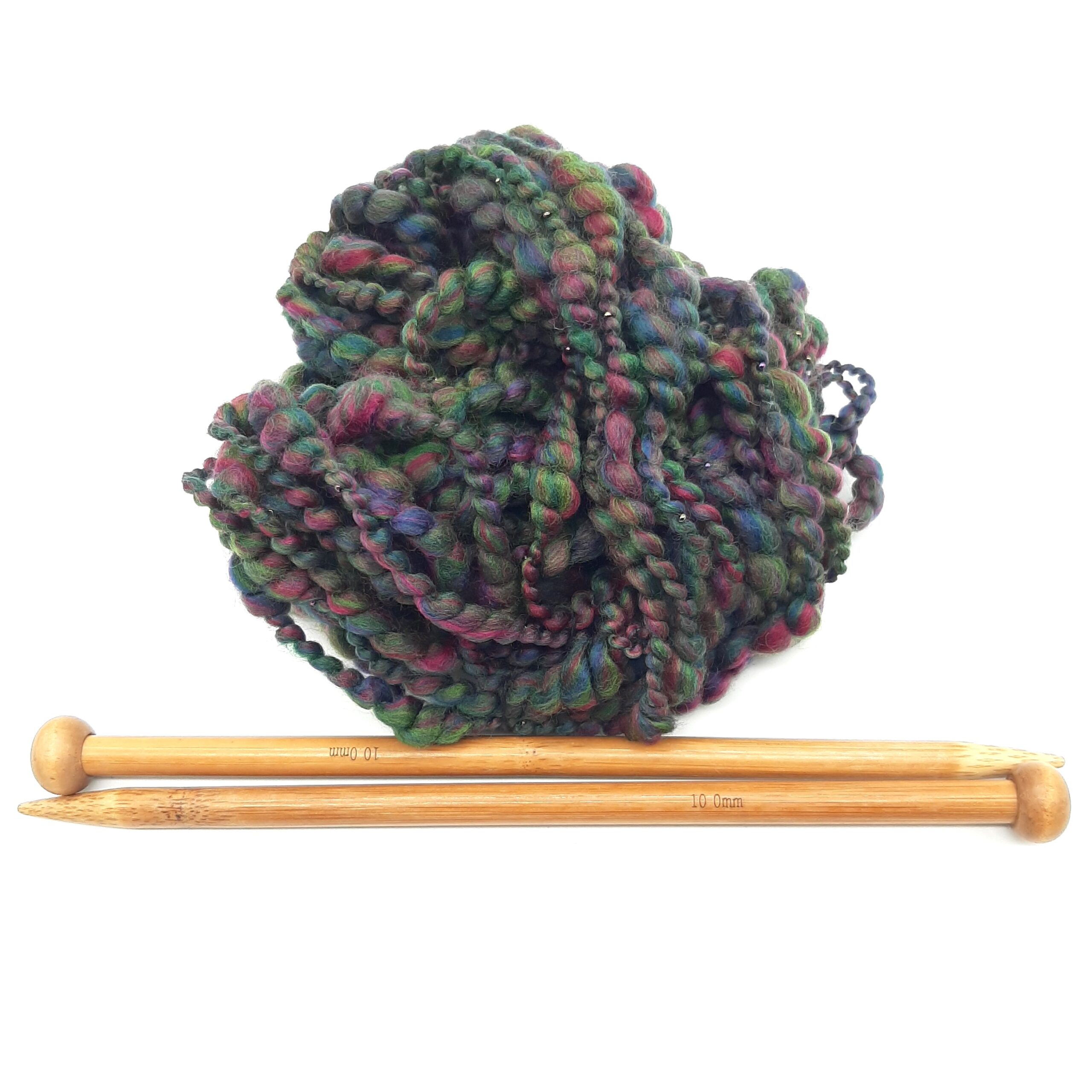 A ball of Evening Heather handspun merino beaded yarn in deep, rich heather colours, above a pair of bamboo knitting needles.
