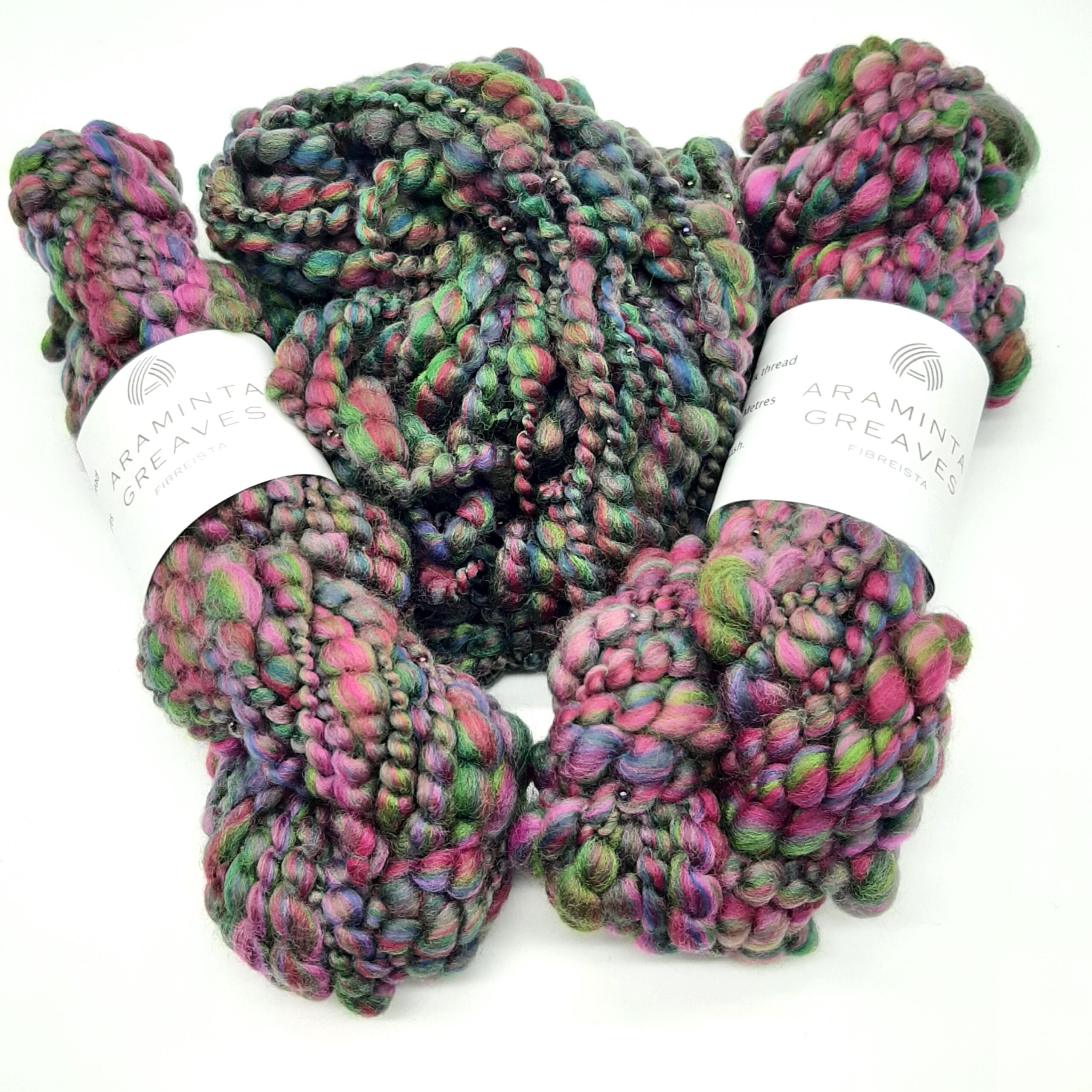 Two skeins and a ball of Evening Heather handspun merino beaded yarn in deep, rich heather colours.