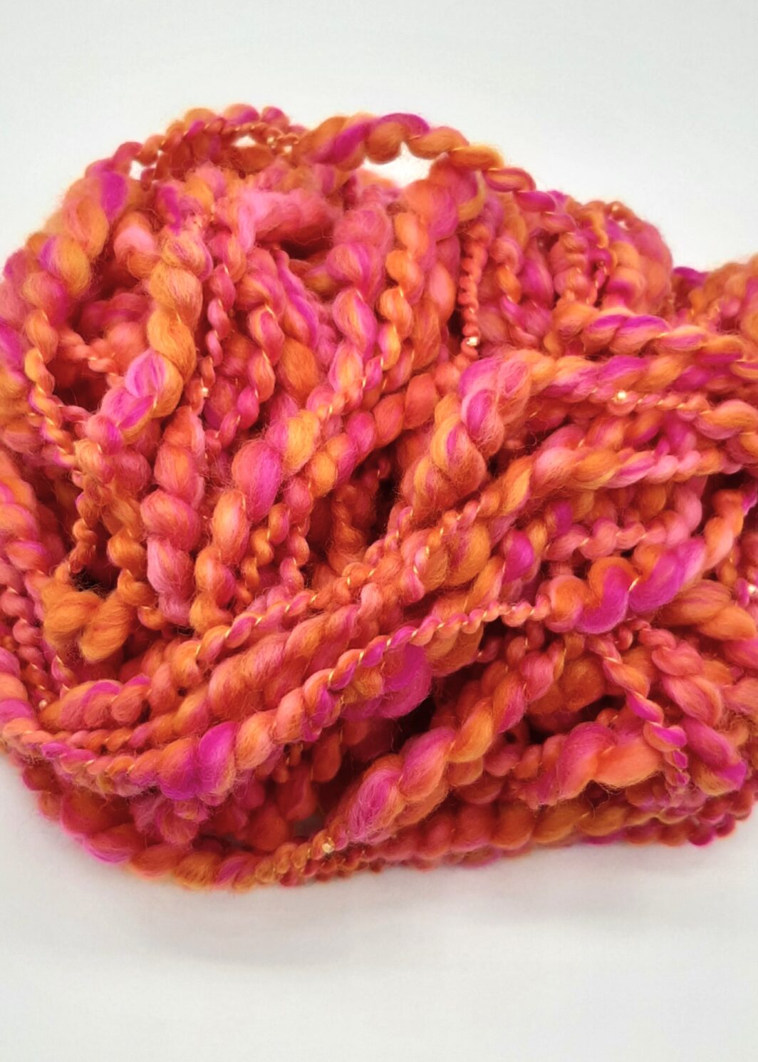 Fruit Salads hand spun merino beaded yarn in vibrant shades of orange and pink.