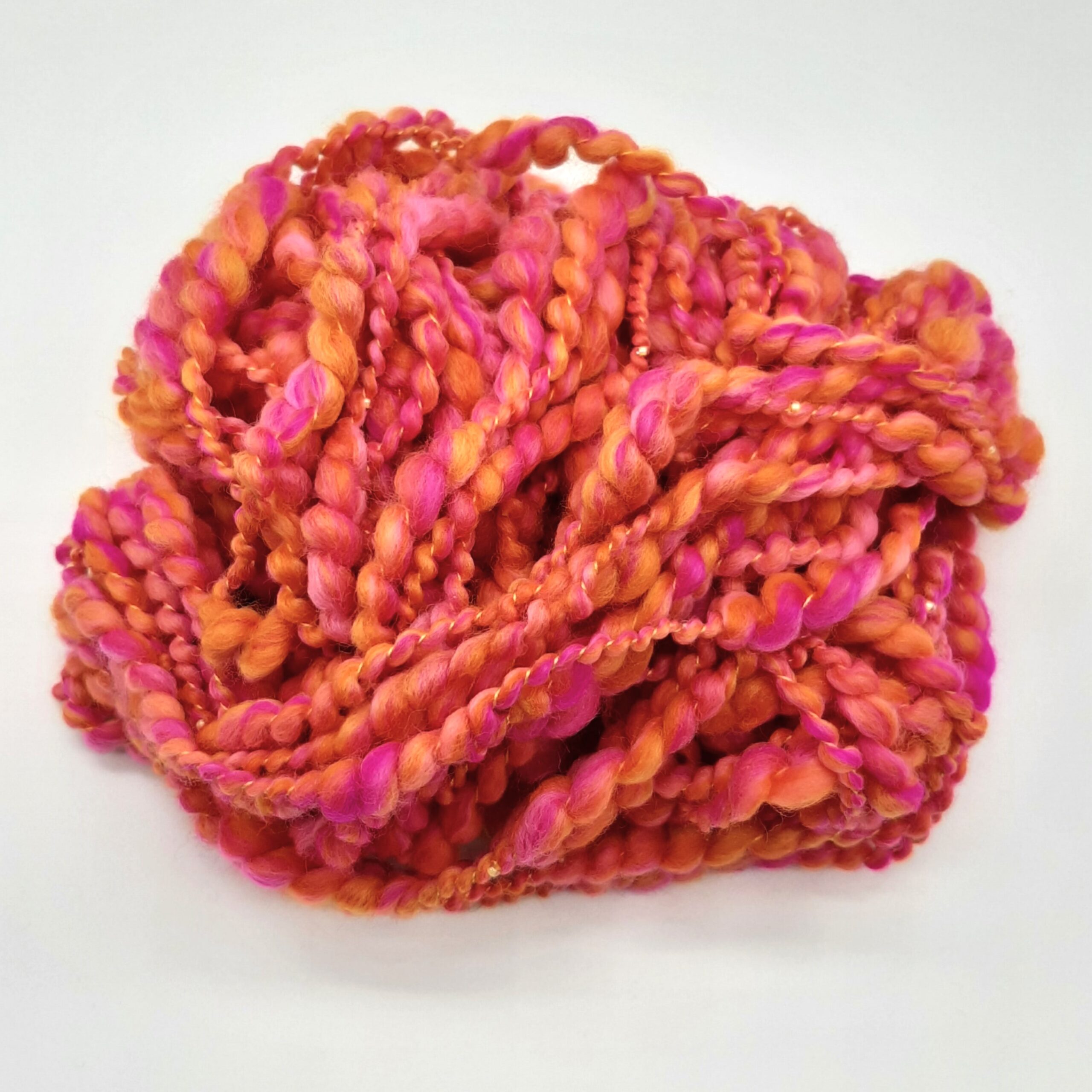 Fruit Salads hand spun merino beaded yarn in vibrant shades of orange and pink.