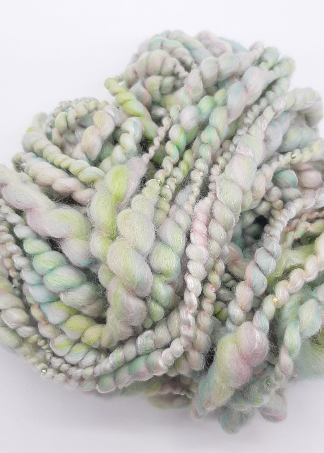 Sherbet Pips handspun, beaded yarn in pastel shades of greens and pinks.