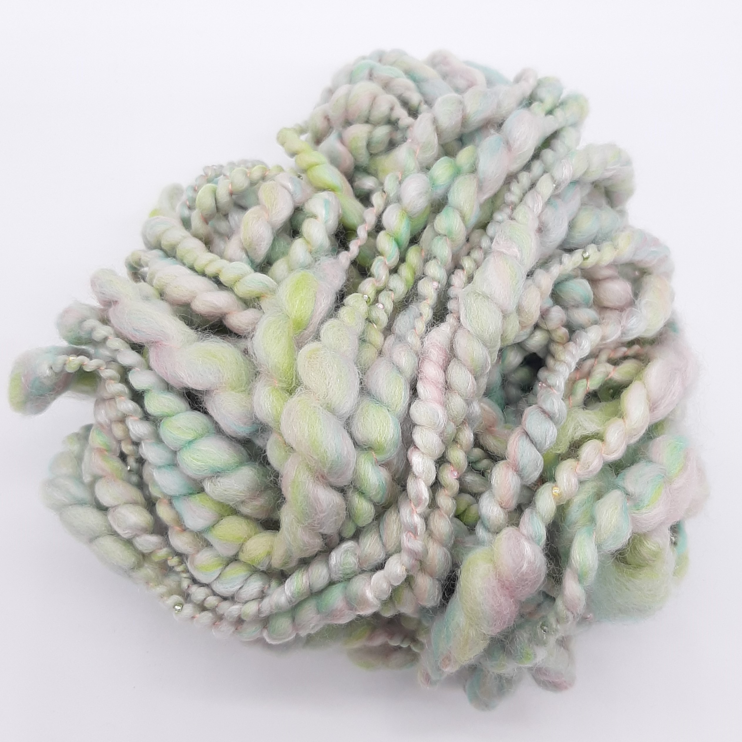 Sherbet Pips handspun, beaded yarn in pastel shades of greens and pinks.
