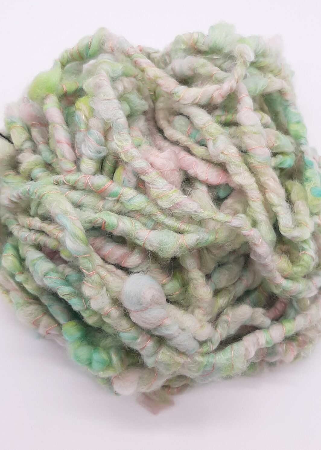 Sherbet Pips corespun, handspun yarn in pastel shades of greens and pinks.