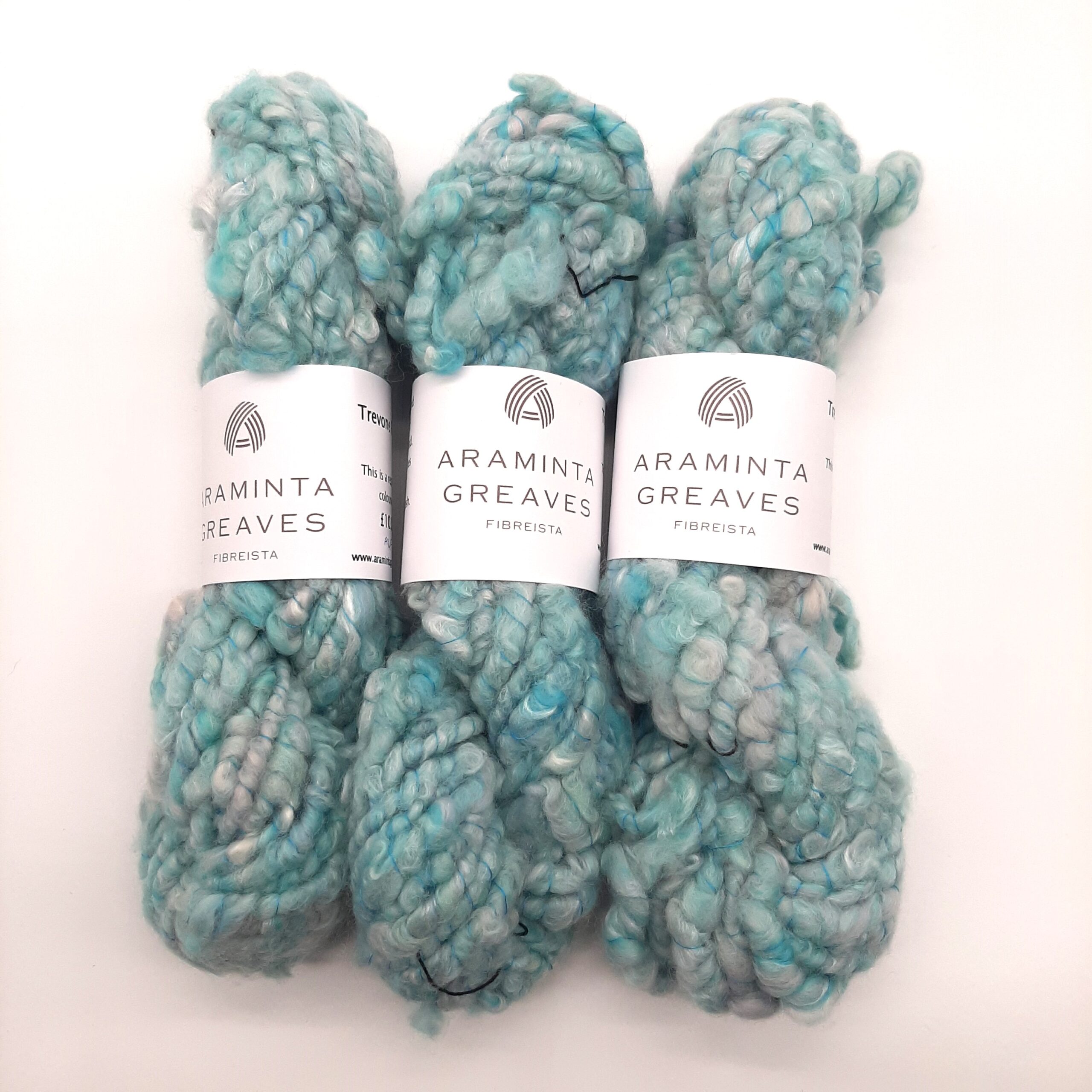 Three skeins of Trevone Foam, handspun corespun merion and silk yarn in pale blue, turquoise and grey.