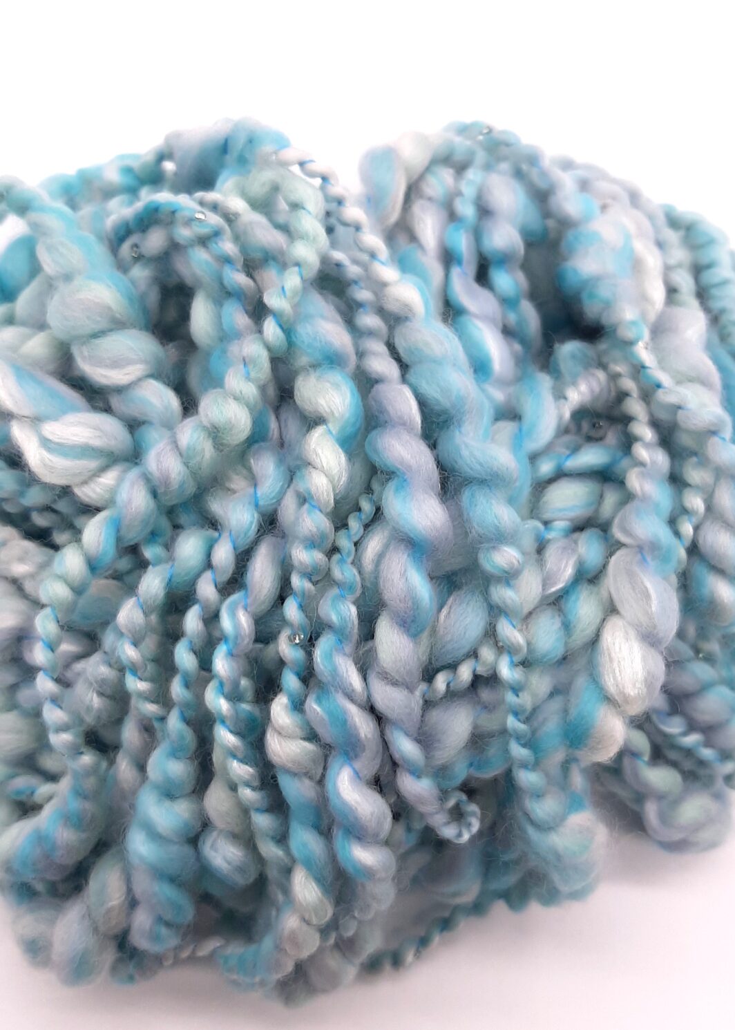 Trevone Foam, handspun beaded merino and silk yarn in pale blue, turquoise and grey.