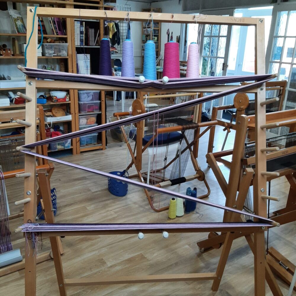 Purple and lilac warp on a Saori warping frame