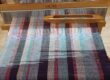 Weaving in shades of purple, pink and blue on the the loom.