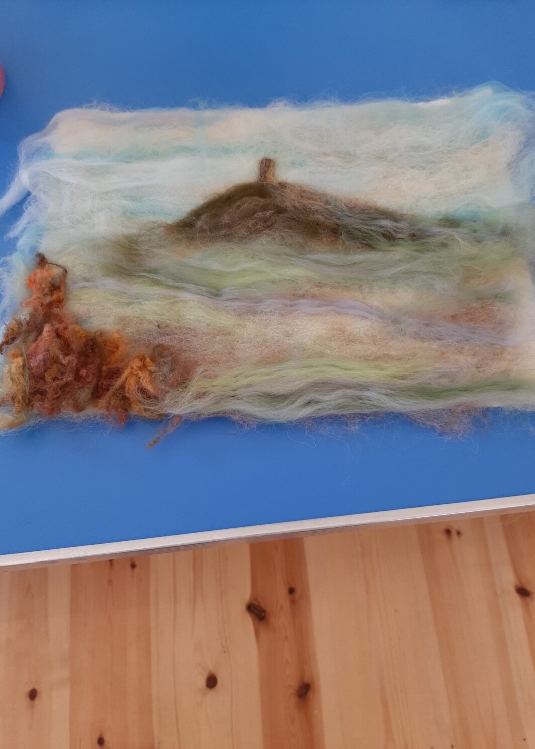 A needlefelt picture depicting Glastonbury Tor in beautiful, misty, pastel colours