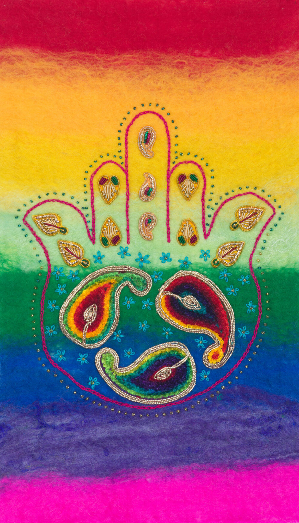 rainbow felt background with a Hamsa stitched in deep pink chain stitch with beaded embellishment