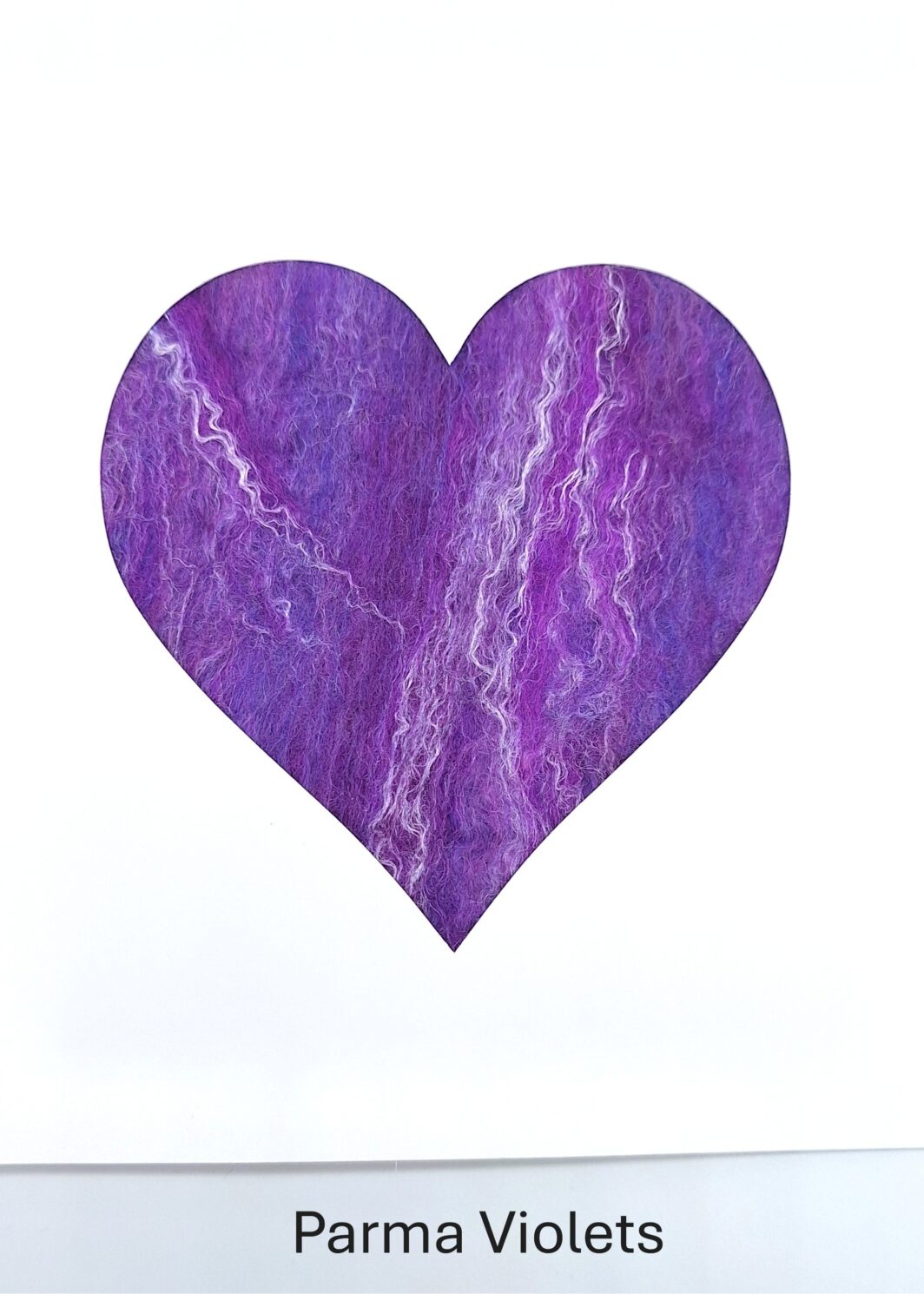 white greeting card with heart shaped aperture filled with shades of purple merino and silk handmade felt in my Parma Violets colourway. Made by Araminta Greaves Fibreista